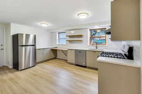 a kitchen with a sink a stove and refrigerator