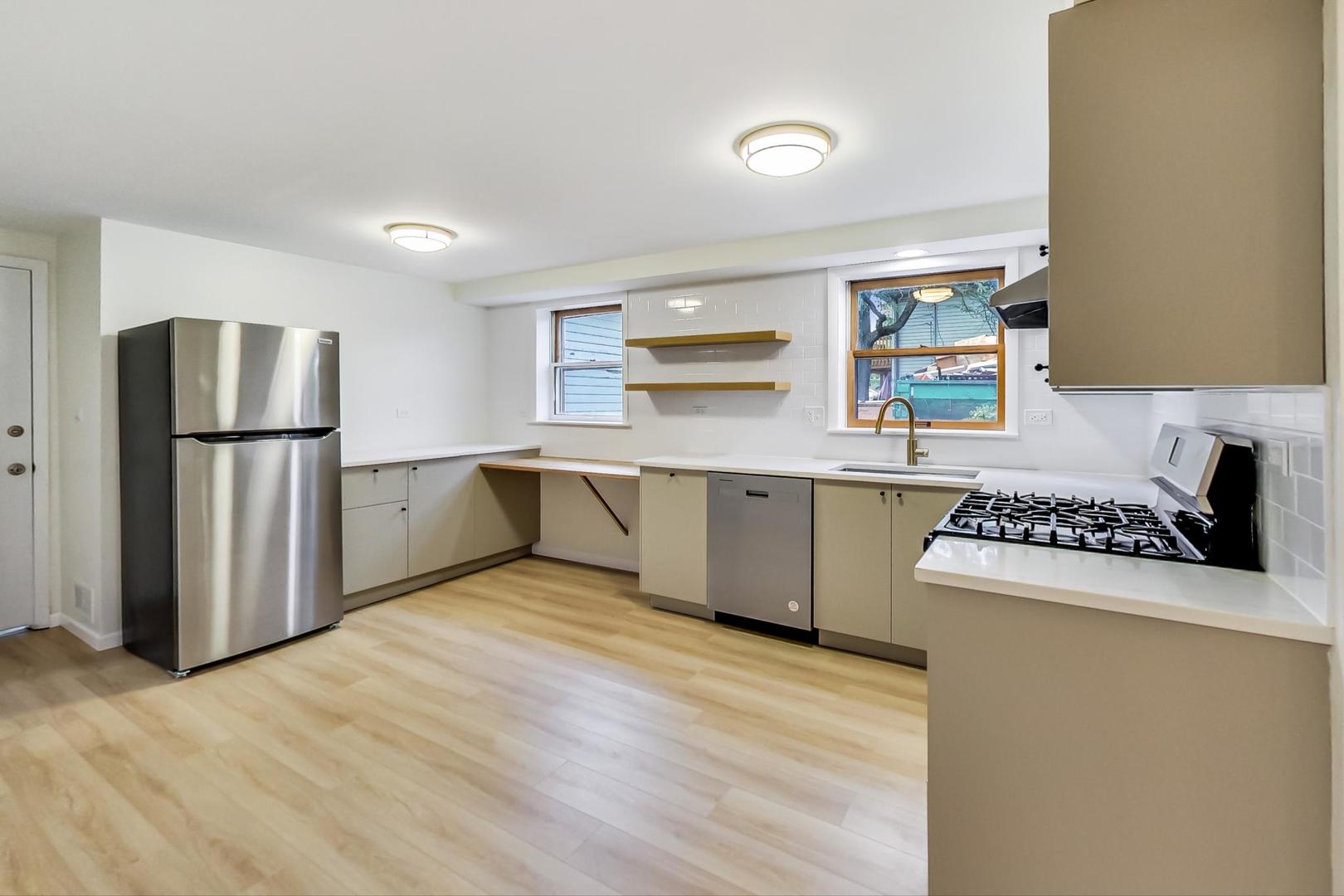 16W674 56th Place Clarendon Hills, IL 60514 - Photo 26 of 41 a kitchen with a sink a stove and refrigerator