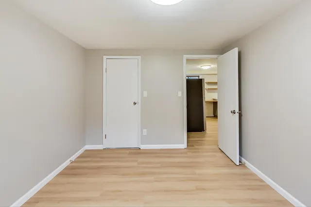 a view of a room with wooden floor