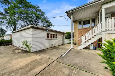 a view of a house with wooden fence