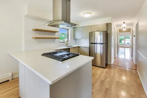 a kitchen with stainless steel appliances a refrigerator and a stove