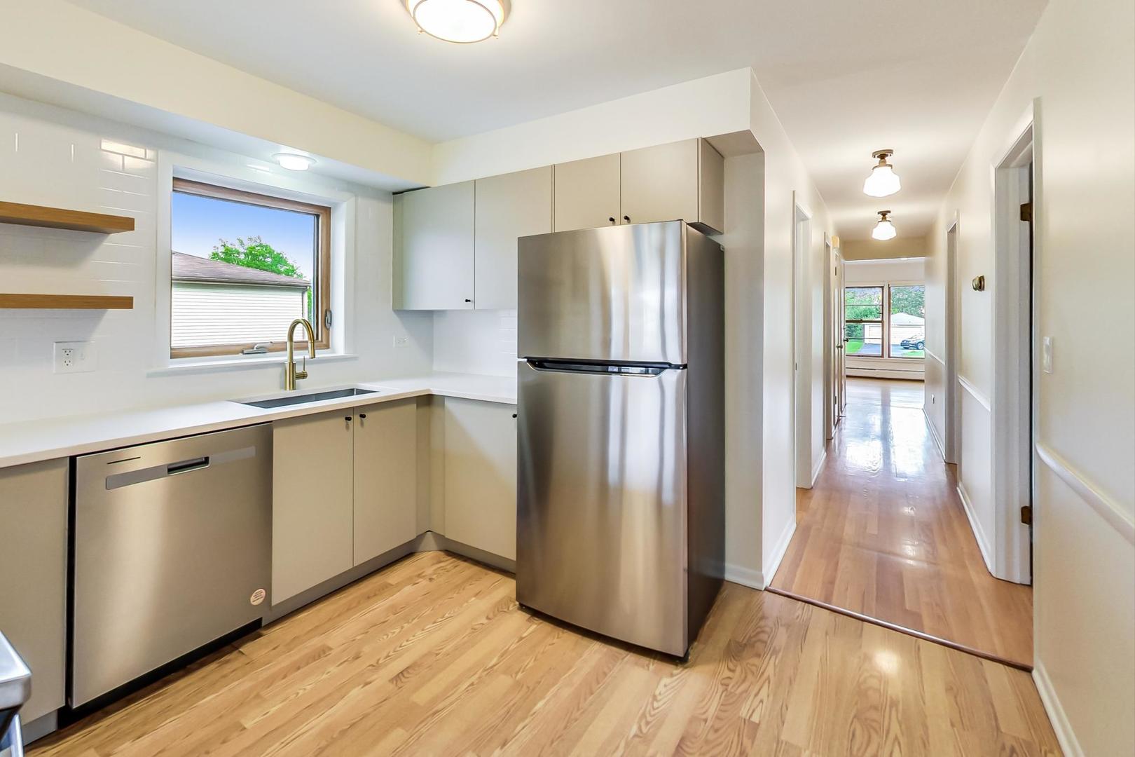 16W674 56th Place Clarendon Hills, IL 60514 - Photo 8 of 41 a kitchen with a refrigerator a sink and a stove top oven