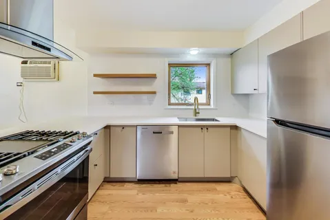 a kitchen with a stove a refrigerator and a sink