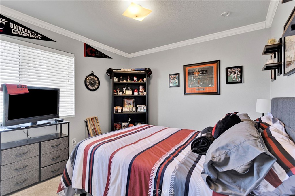 20403 Ochoa Road Apple Valley, CA 92307 - Photo 38 of 48 a bedroom with a bed and a flat screen tv
