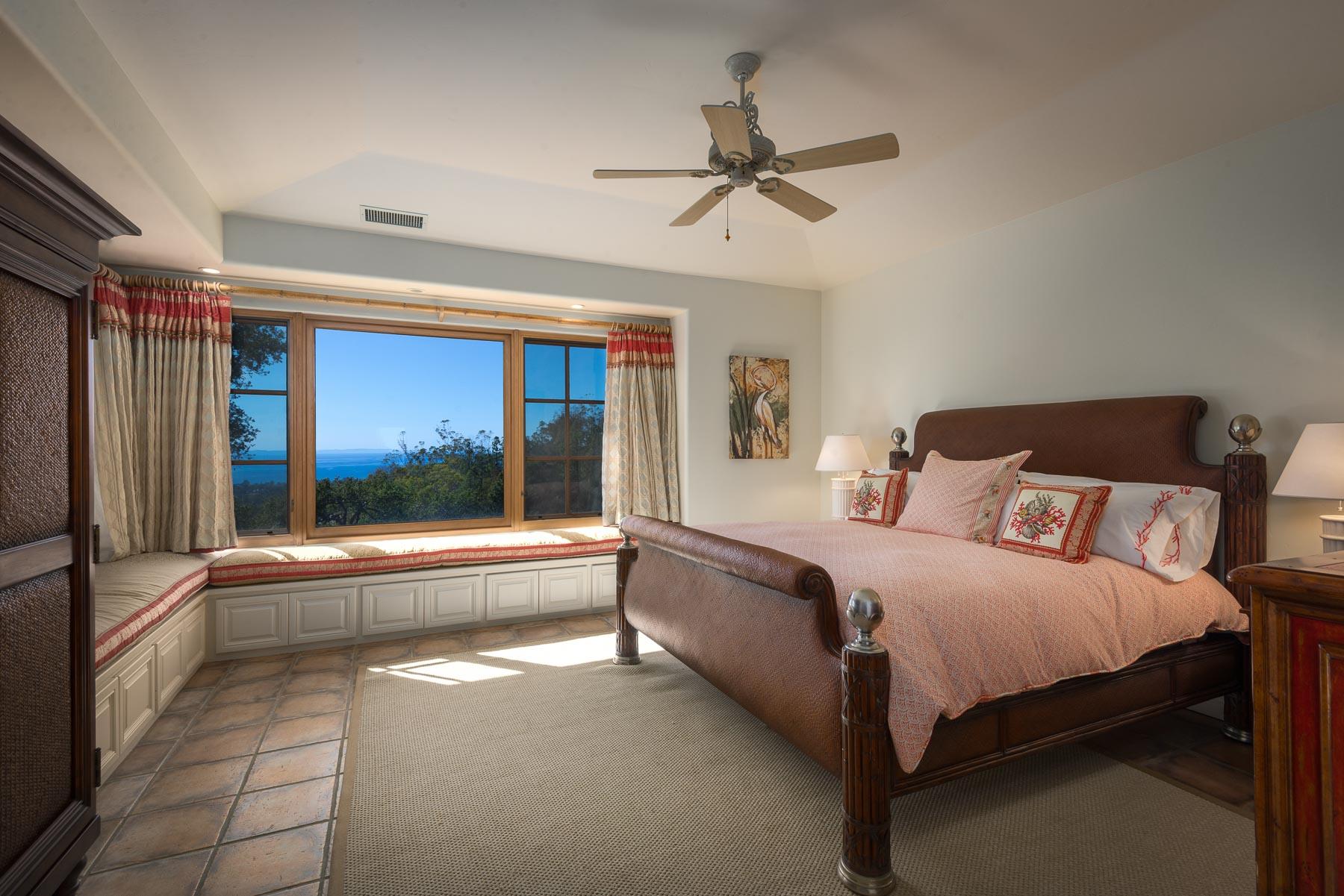 2220 Bella Vista Drive Montecito, CA 93108 - Photo 17 of 27 a large bedroom with a large bed and a chandelier fan