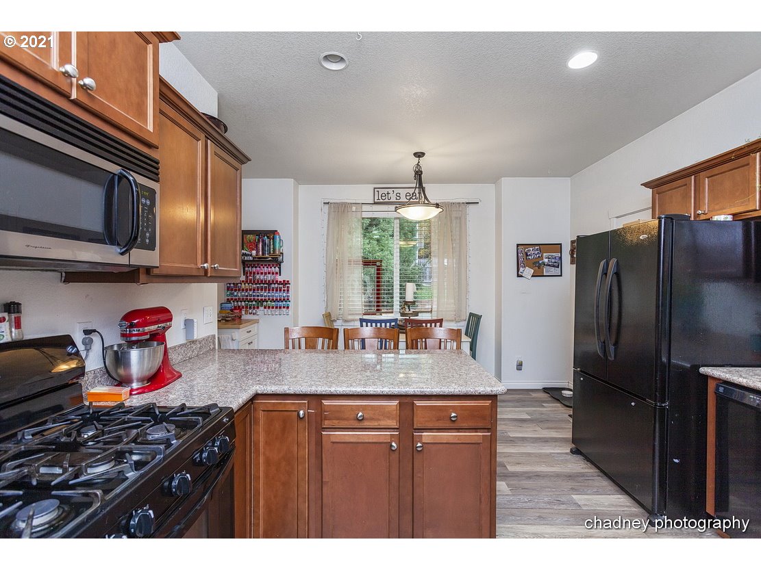 39591 Dubarko Road Sandy, OR 97055 - Photo 8 of 23 a kitchen with stainless steel appliances granite countertop a stove refrigerator and cabinets