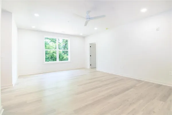 an empty room with windows and closet