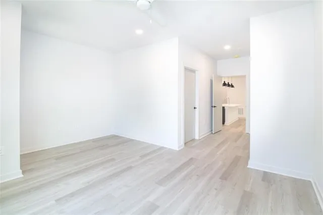 a view of a hallway with wooden floor