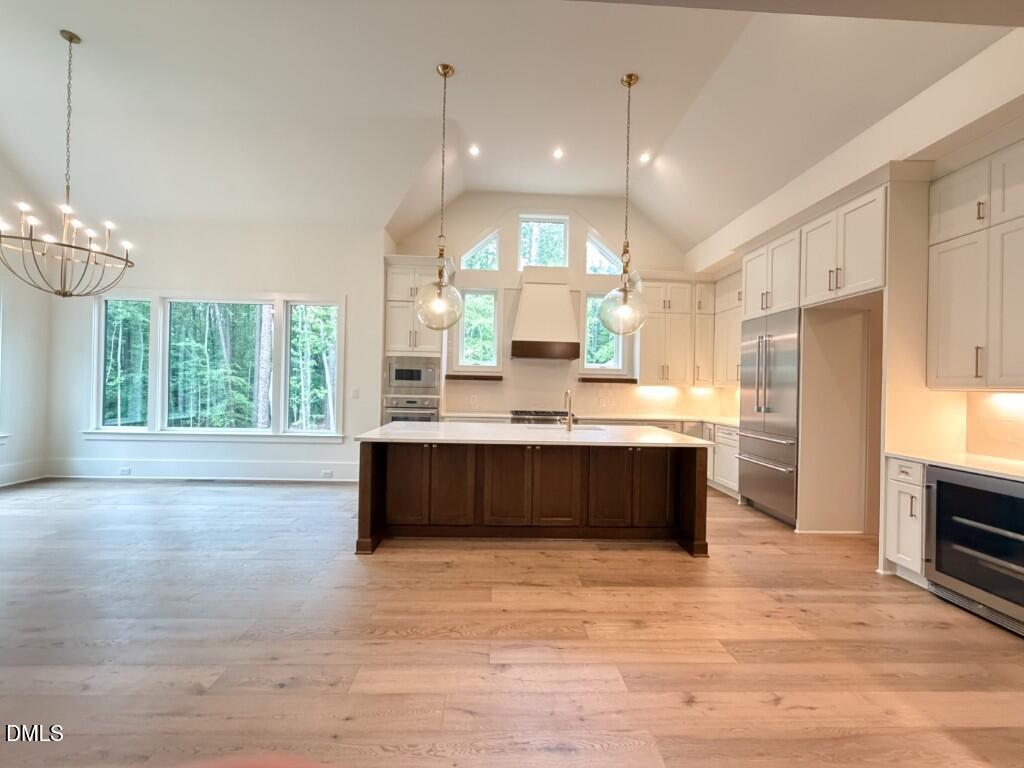 7441 Summer Tanager Trail Raleigh, NC 27614 - Photo 8 of 48 a large kitchen with kitchen island a sink stainless steel appliances and cabinets