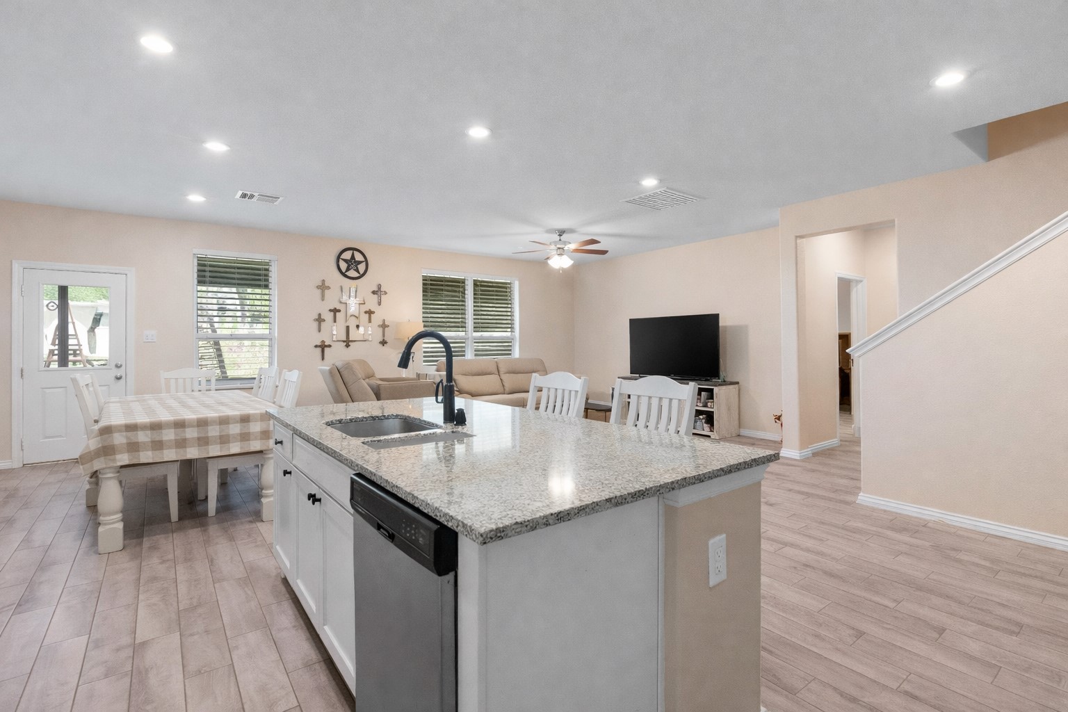 14499 Sunny Bend Way Conroe, TX 77303 - Photo 12 of 41 a open kitchen with stainless steel appliances granite countertop a sink stove and wooden floor