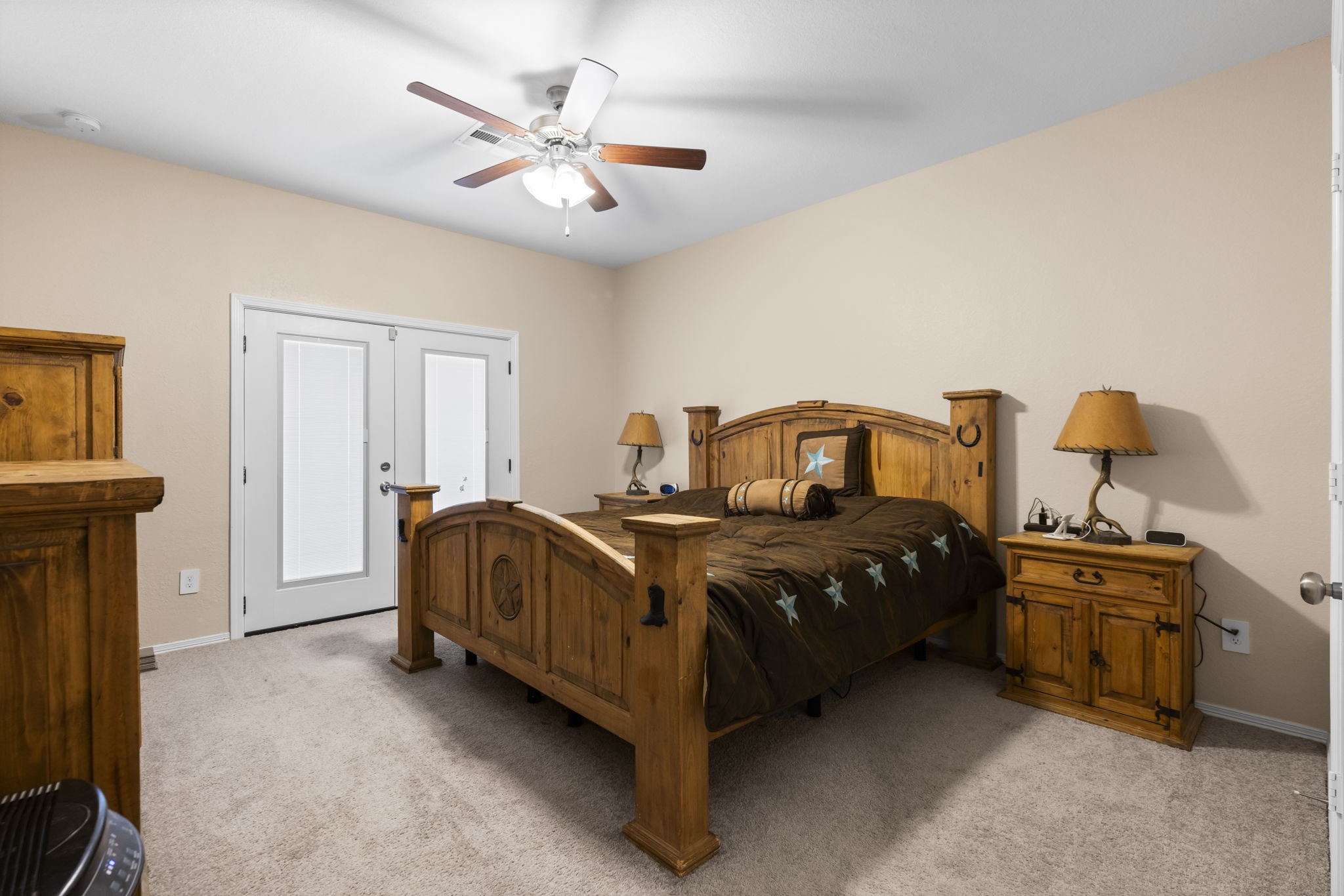 14499 Sunny Bend Way Conroe, TX 77303 - Photo 16 of 41 a bedroom with a bed and a chandelier