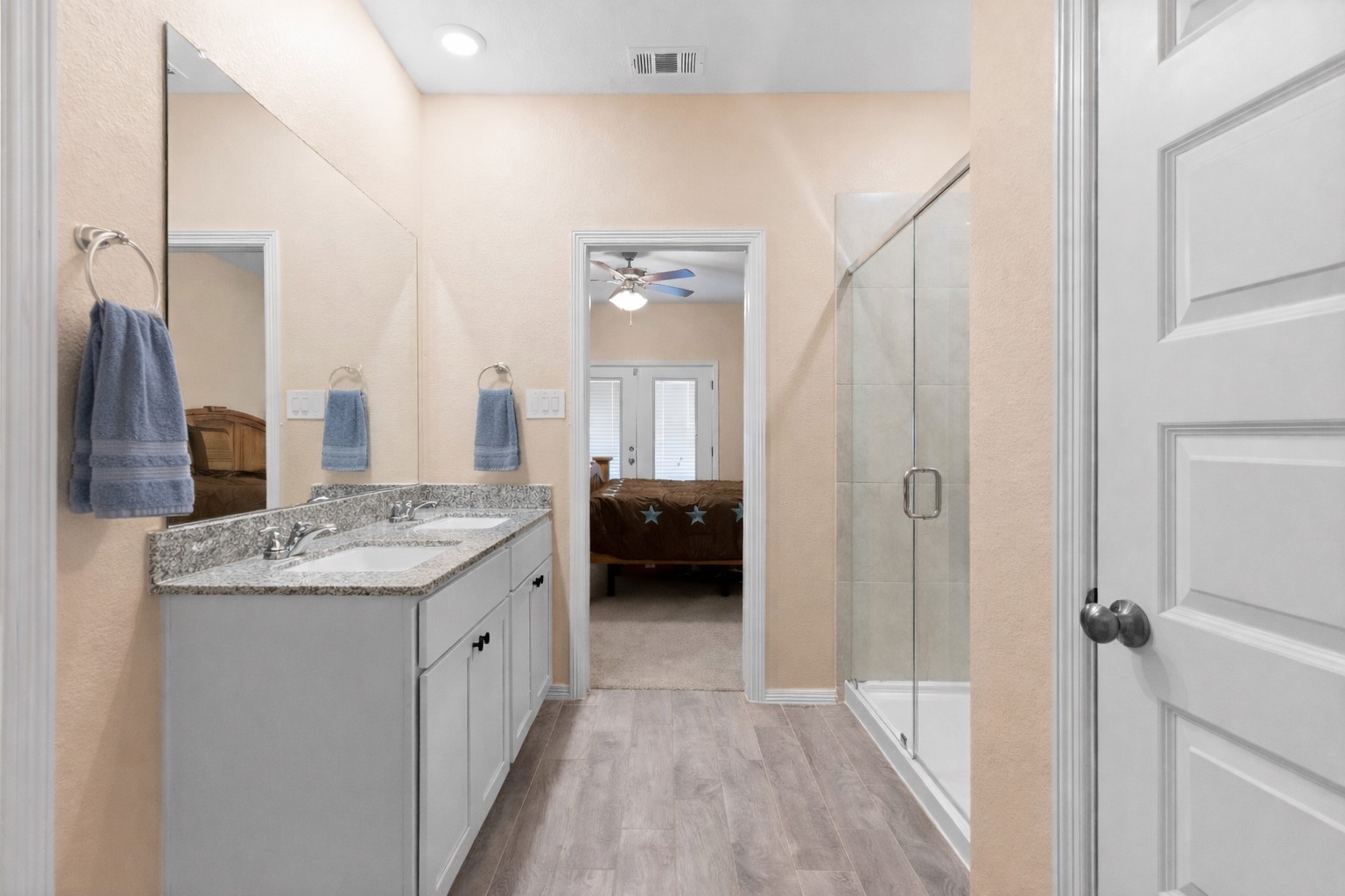 14499 Sunny Bend Way Conroe, TX 77303 - Photo 18 of 41 a bathroom with a granite countertop sink a mirror and a shower