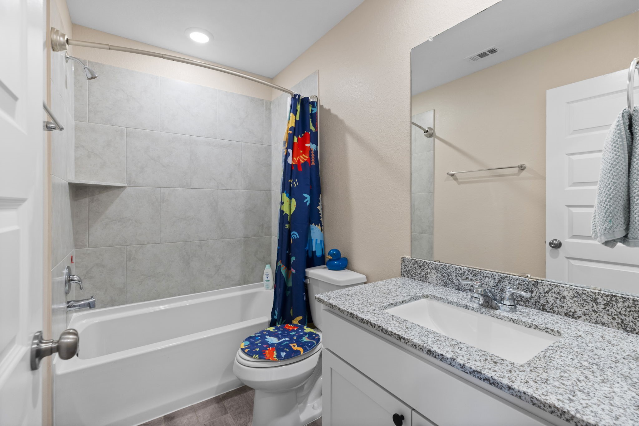 14499 Sunny Bend Way Conroe, TX 77303 - Photo 23 of 41 a bathroom with a granite countertop sink a toilet and shower