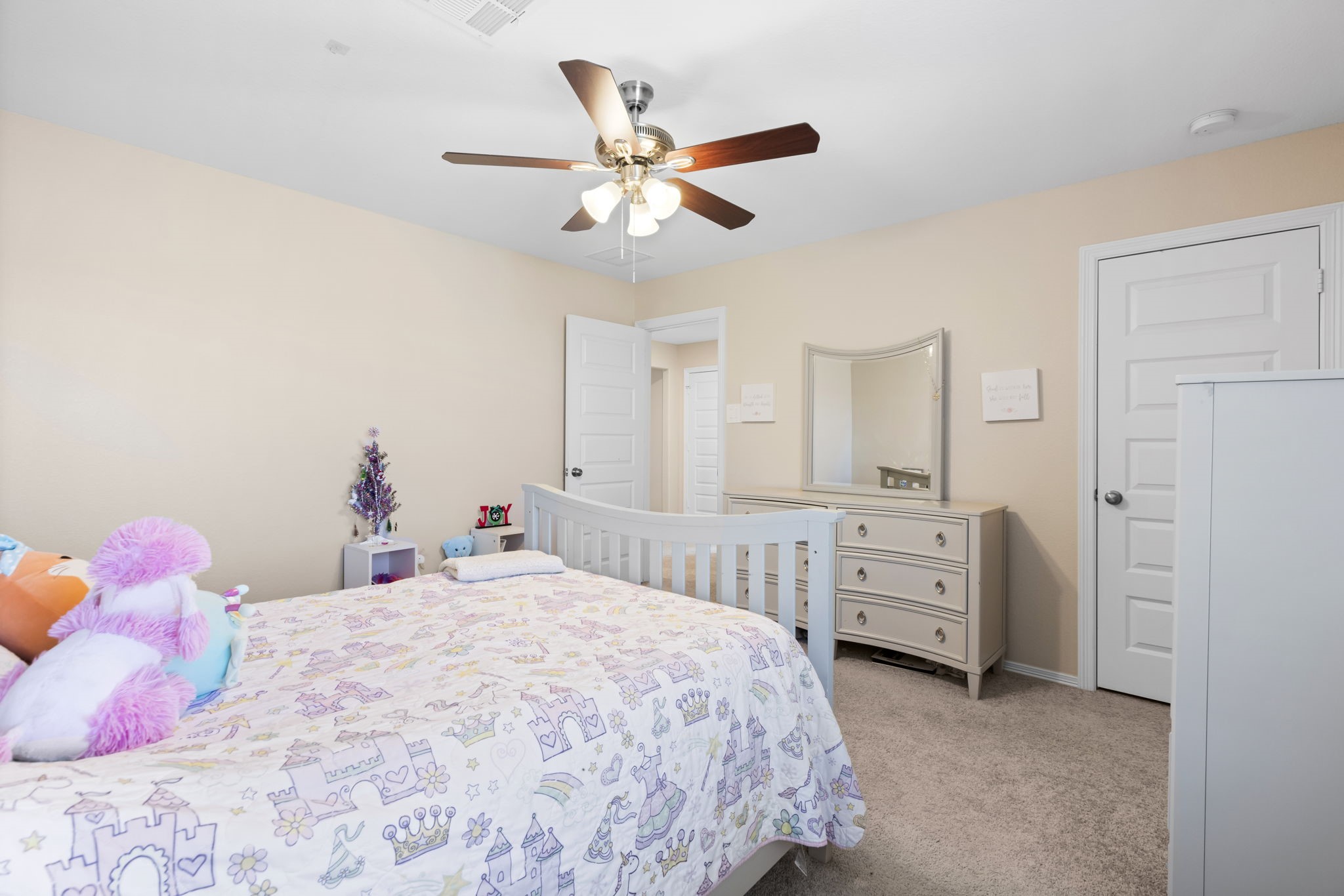 14499 Sunny Bend Way Conroe, TX 77303 - Photo 27 of 41 a bedroom with a bed and a chandelier