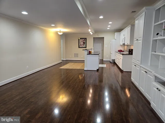 a view of kitchen with cabinets and wooden floor