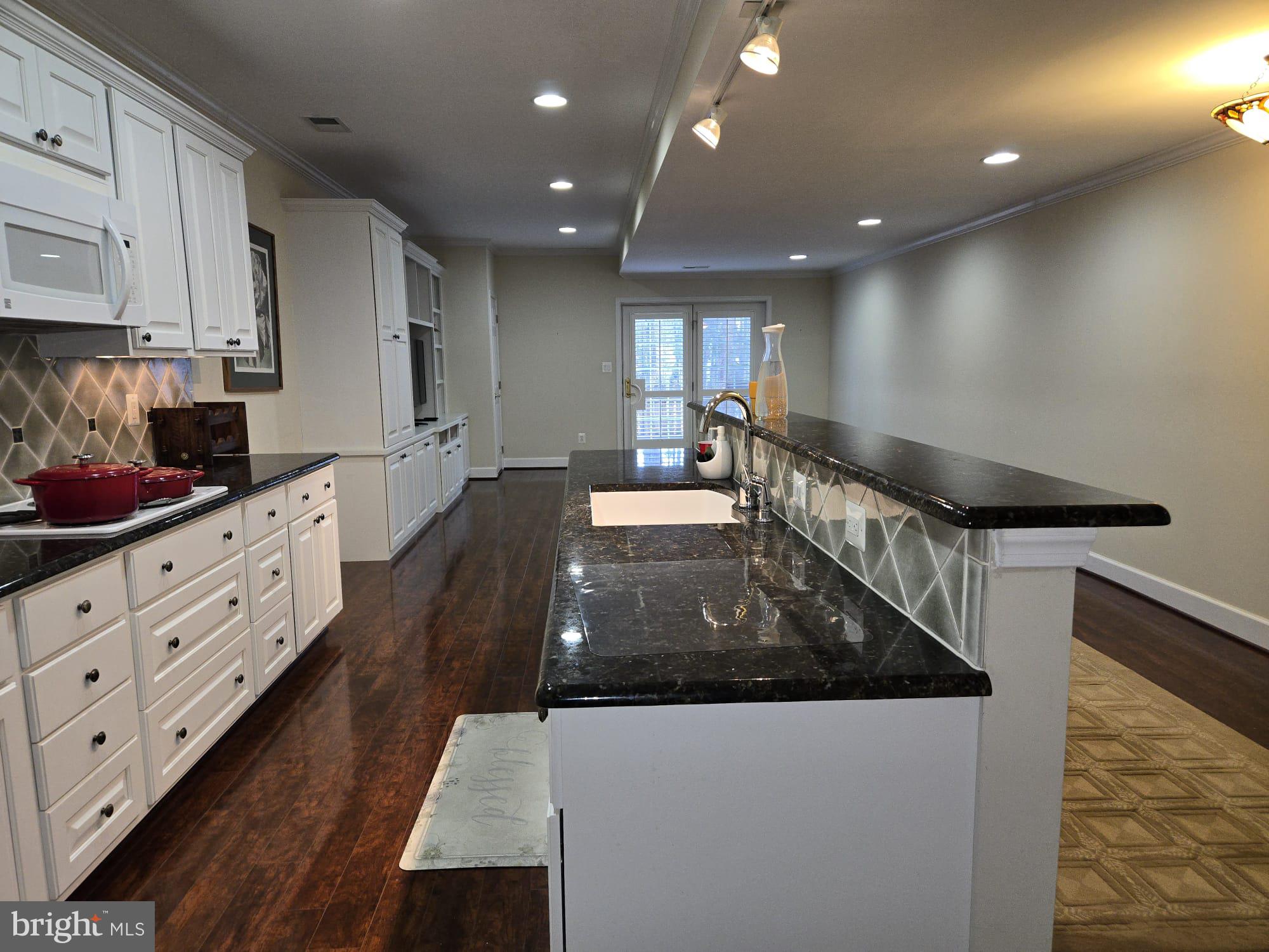 25170 Fortitude Terrace Chantilly, VA 20152 - Photo 34 of 50 a large kitchen with stainless steel appliances a large counter top a stove and a refrigerator
