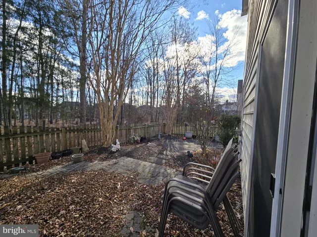 a view of a bench in the backyard