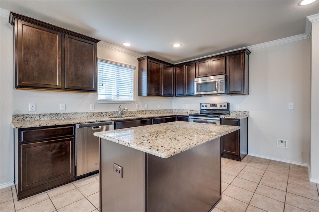 1420 Rivers Creek Lane Little Elm, TX 75068 - Photo 7 of 25 a kitchen with stainless steel appliances granite countertop a sink stove and refrigerator