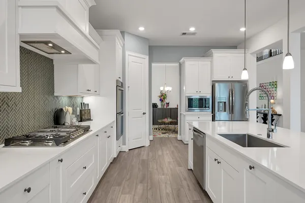a kitchen with a sink stove and refrigerator