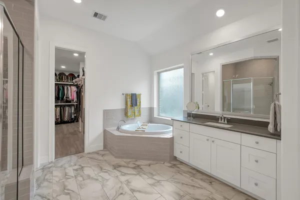 a spacious bathroom with a double vanity sink and a mirror