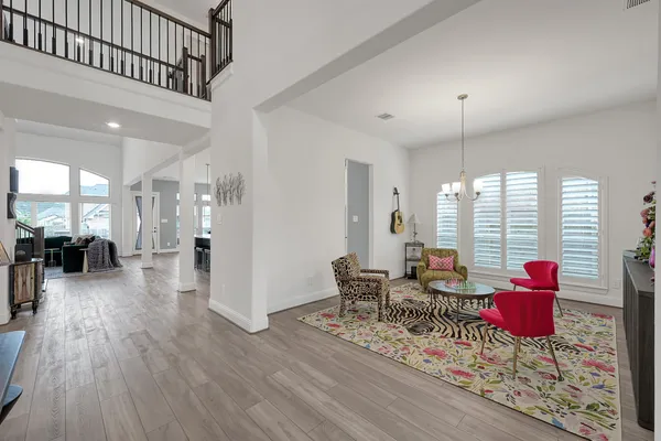 a living room with furniture and wooden floor