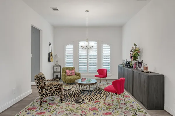 a living room with furniture and a chandelier