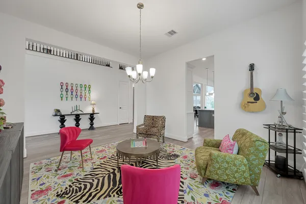 a living room with furniture and a chandelier
