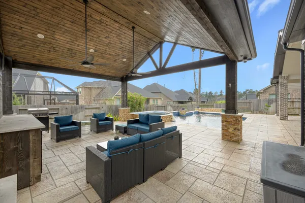 a living room with patio furniture and a tub
