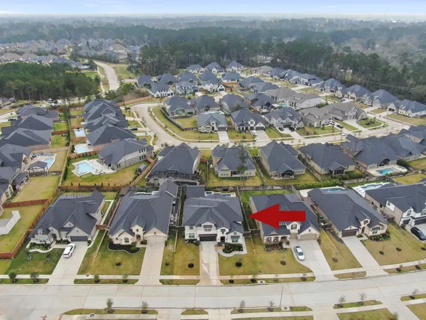an aerial view of residential houses with outdoor space