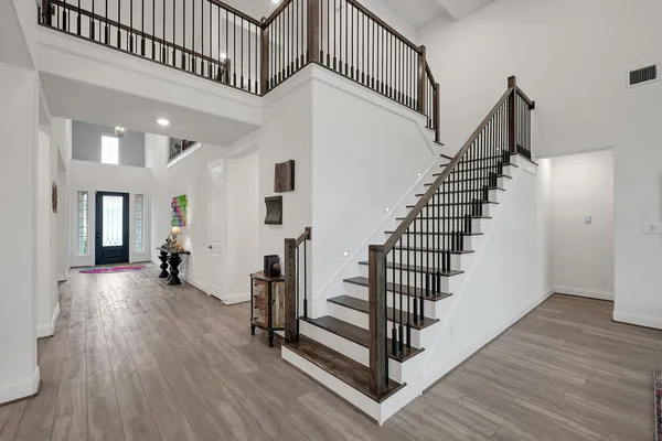 a view of entryway with wooden floor and stairs