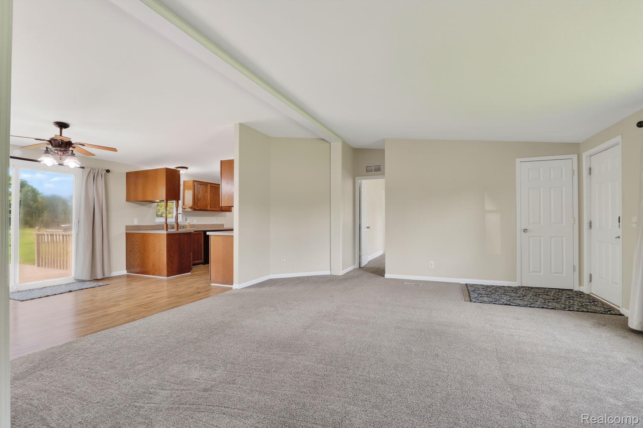 4050 West Thompson Road Linden, MI 48451 - Photo 10 of 36 Unfurnished living room featuring a ceiling fan and light carpet