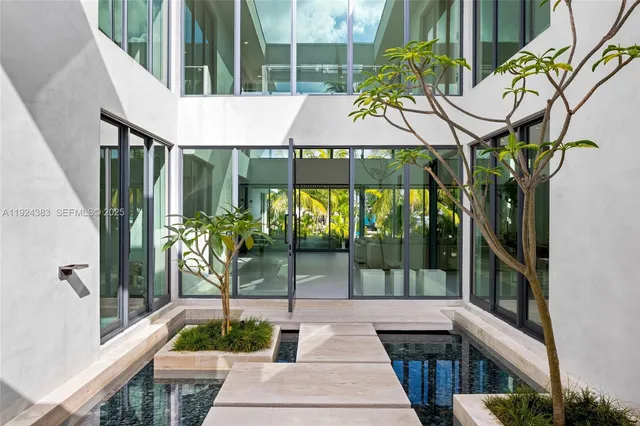 a kitchen with sink and view of living room