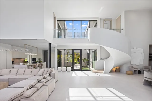 a view of an empty room with wooden floor and chair