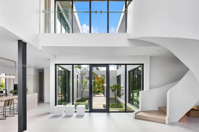 a dining room with furniture and a floor to ceiling window