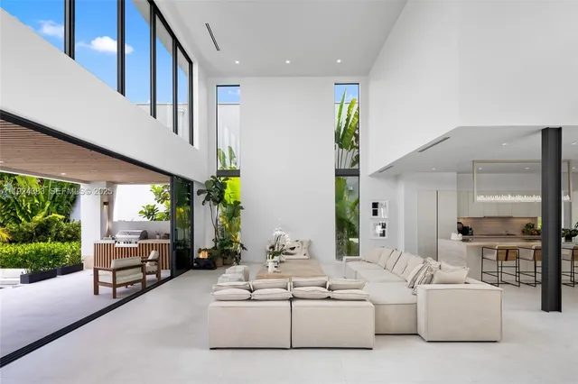 a bedroom with a bed and large windows