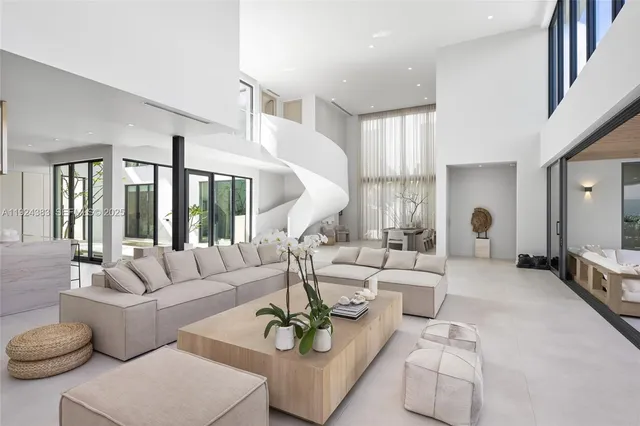 a bedroom with a balcony a large bed and a large window