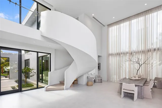 a bedroom with a bed and large window