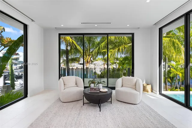 a living room with furniture and a floor to ceiling window
