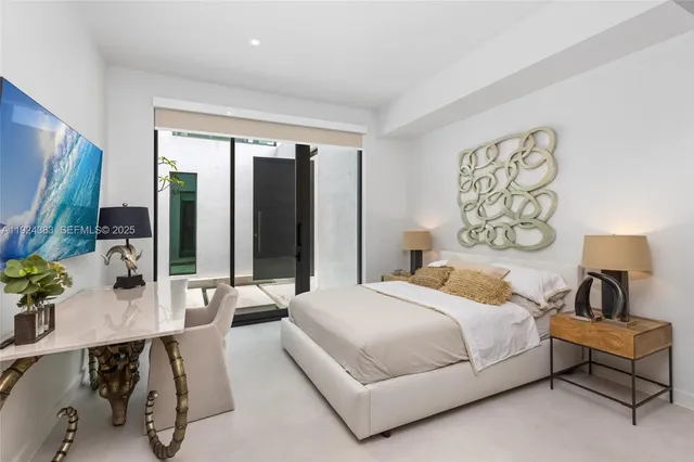 an aerial view of a city with lots of residential buildings ocean and mountain view in back