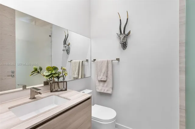 an aerial view of residential houses with outdoor space and ocean view