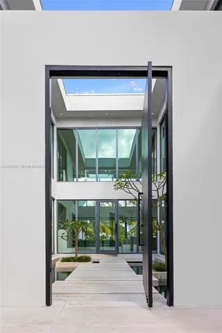 a kitchen with white cabinets and chairs