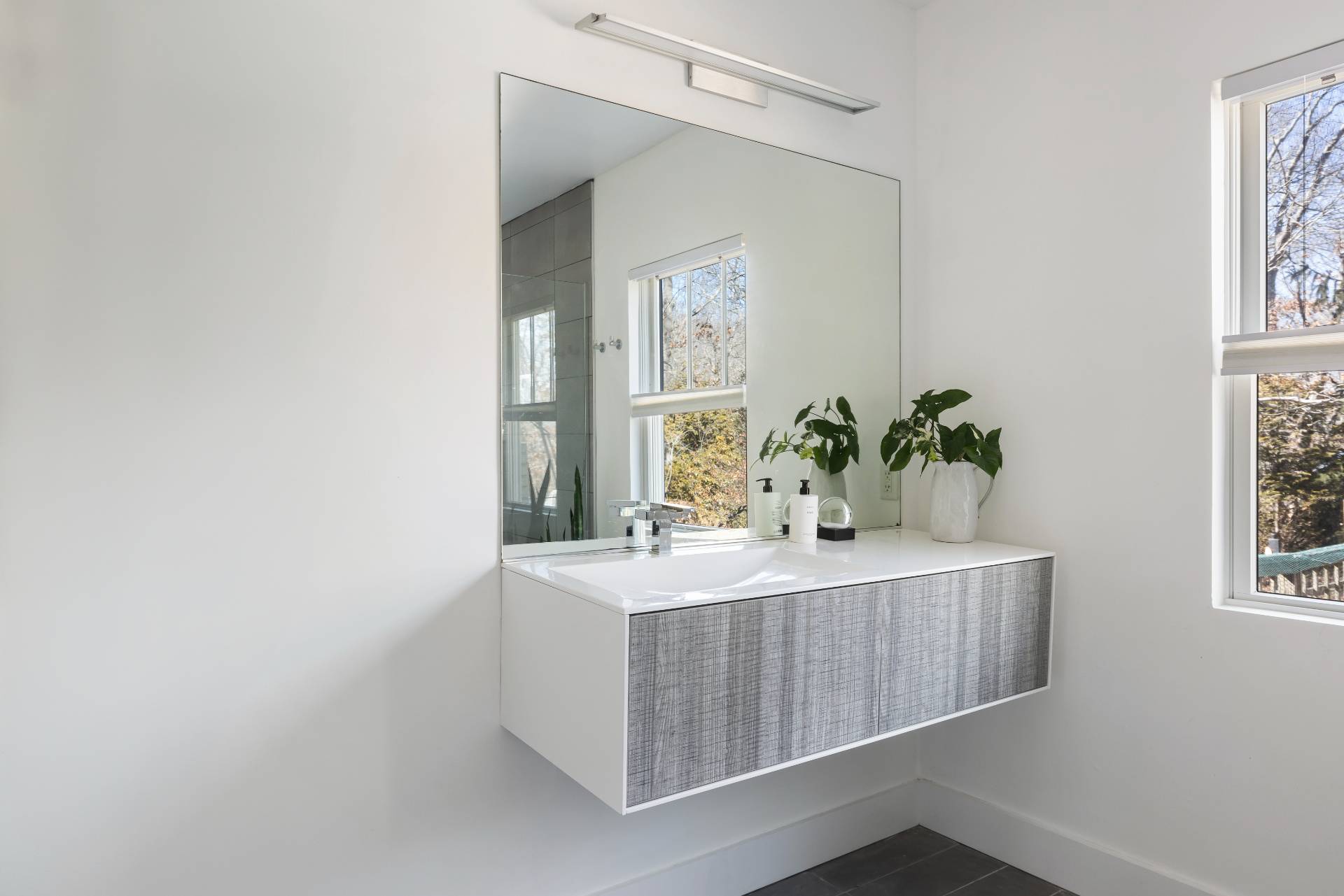 569 Toppings Path Sagaponack, NY 11962 - Photo 12 of 30 a bath room with a sink and a mirror
