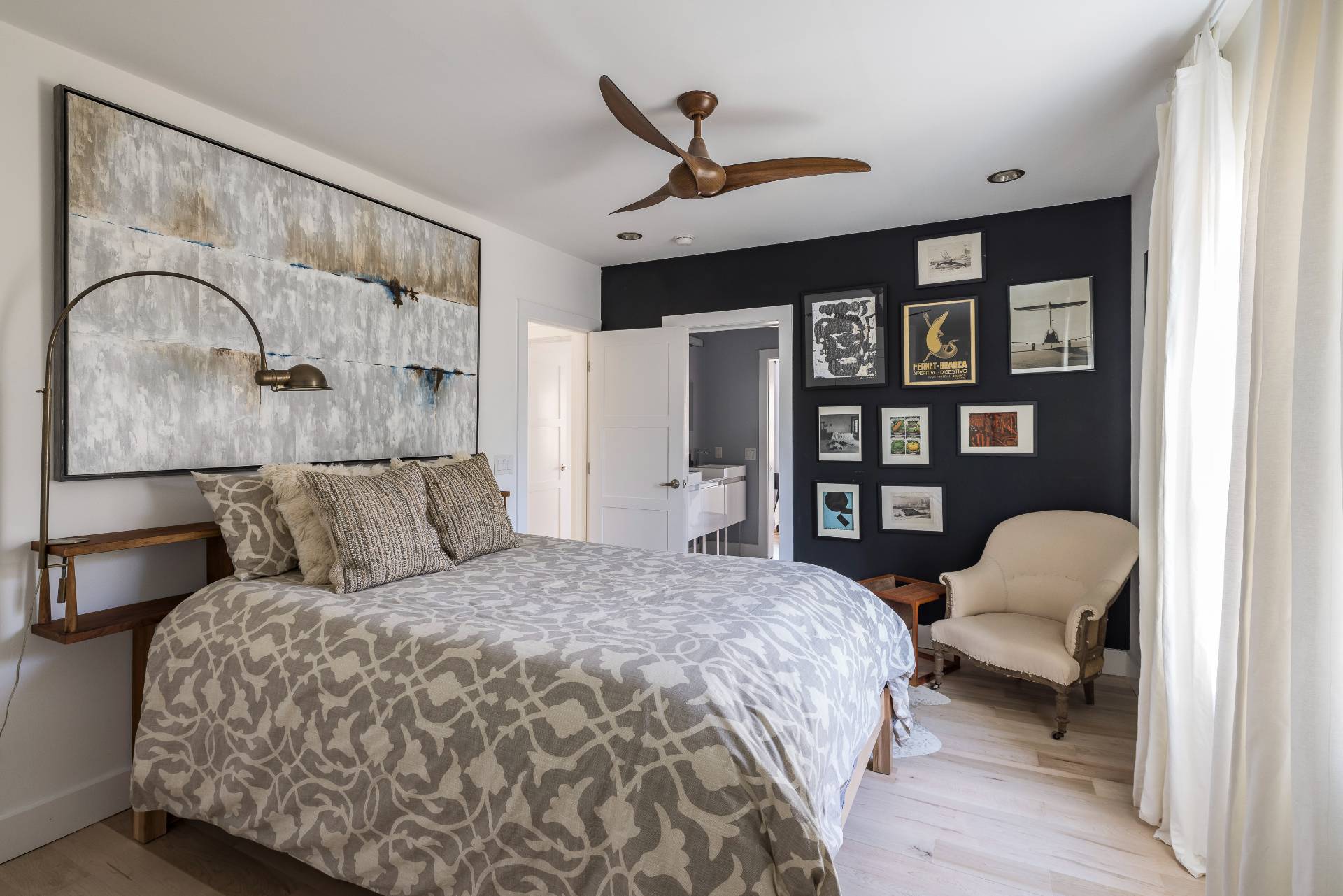 569 Toppings Path Sagaponack, NY 11962 - Photo 22 of 30 a bedroom with a bed wooden floor and book shelf
