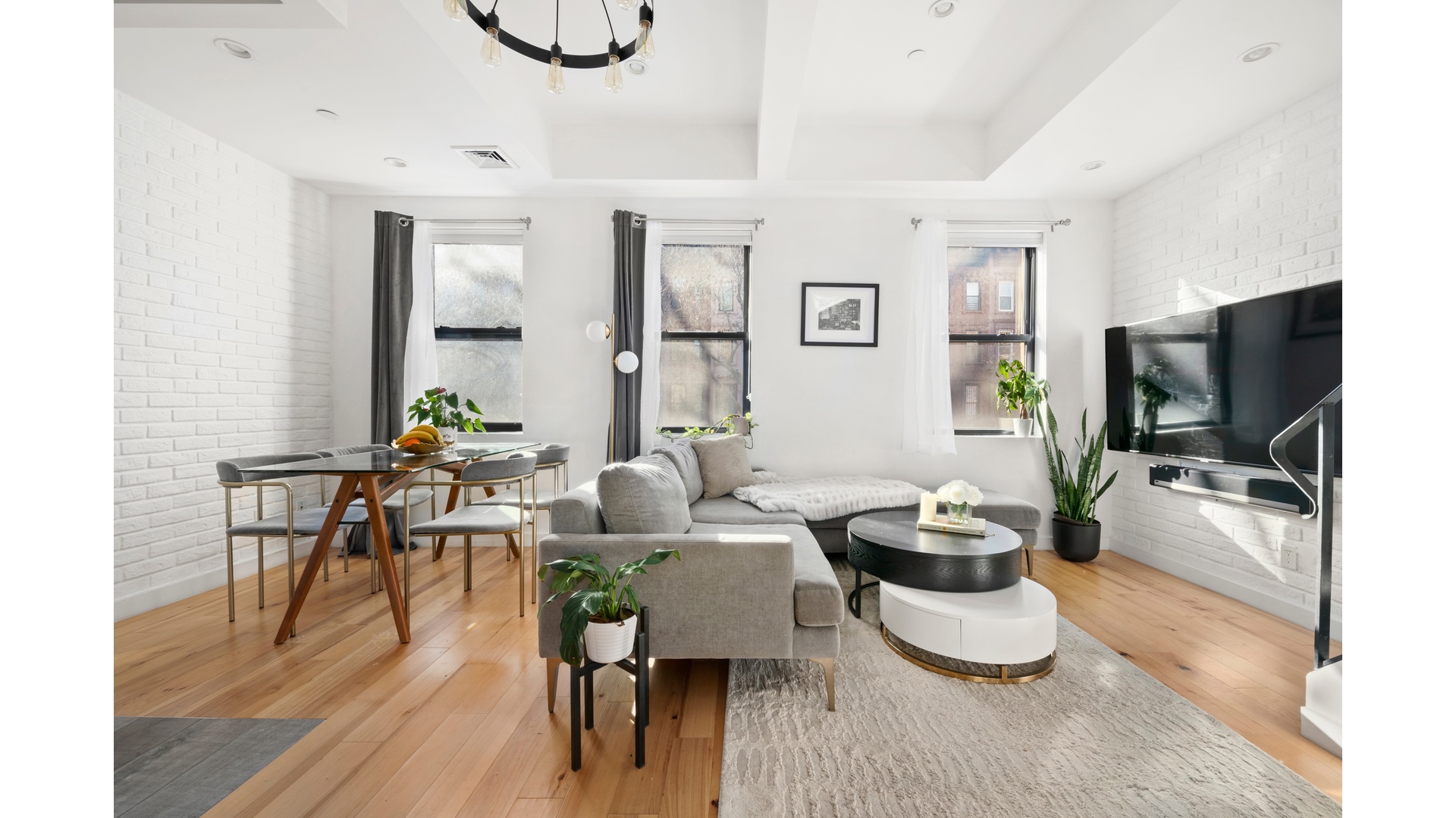 577 Madison Street, Unit 2A Brooklyn, NY 11221 - Photo 1 of 14 a living room with furniture a flat screen tv and a dining table