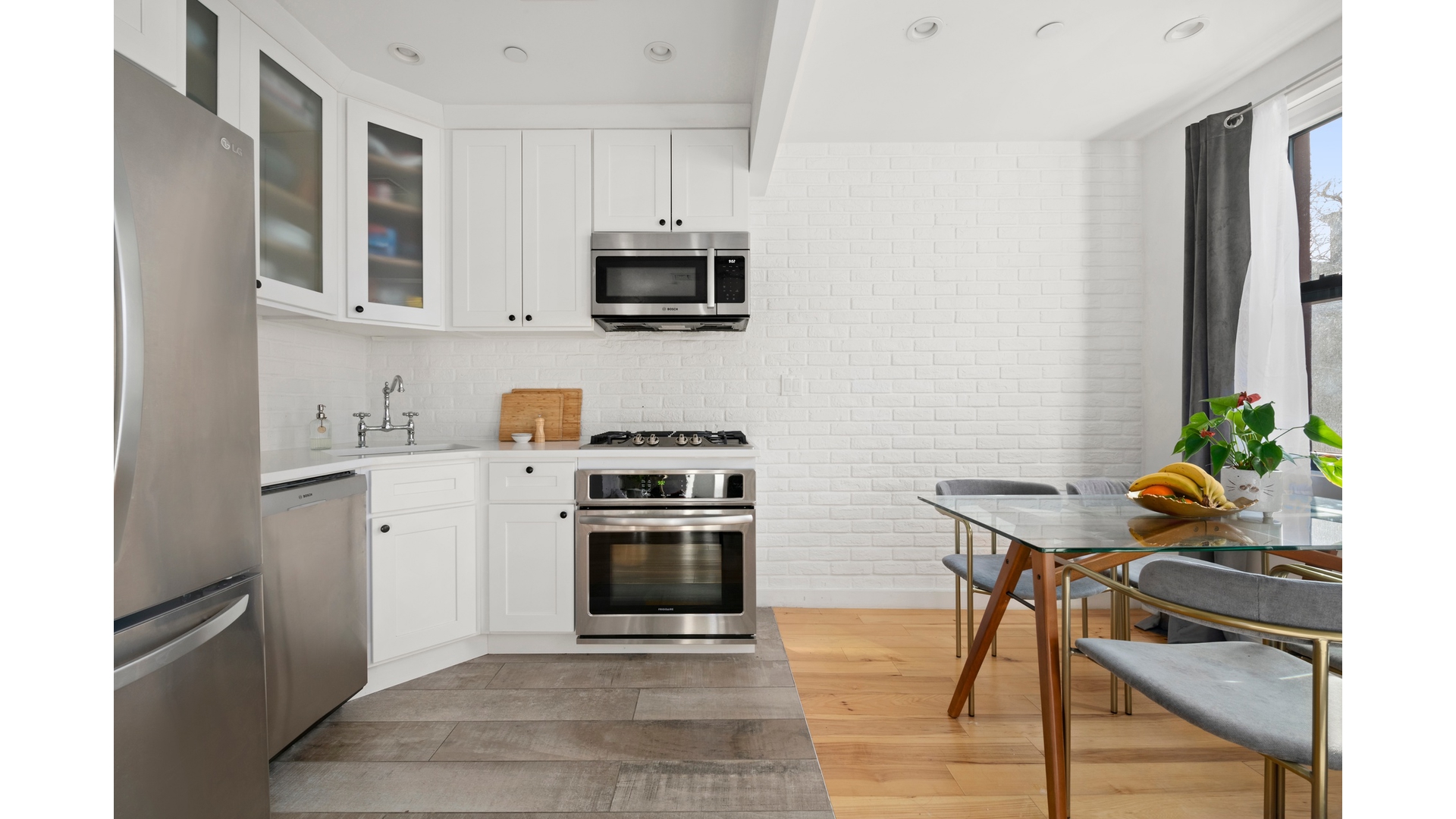 577 Madison Street, Unit 2A Brooklyn, NY 11221 - Photo 2 of 14 a kitchen with stainless steel appliances a stove microwave and sink