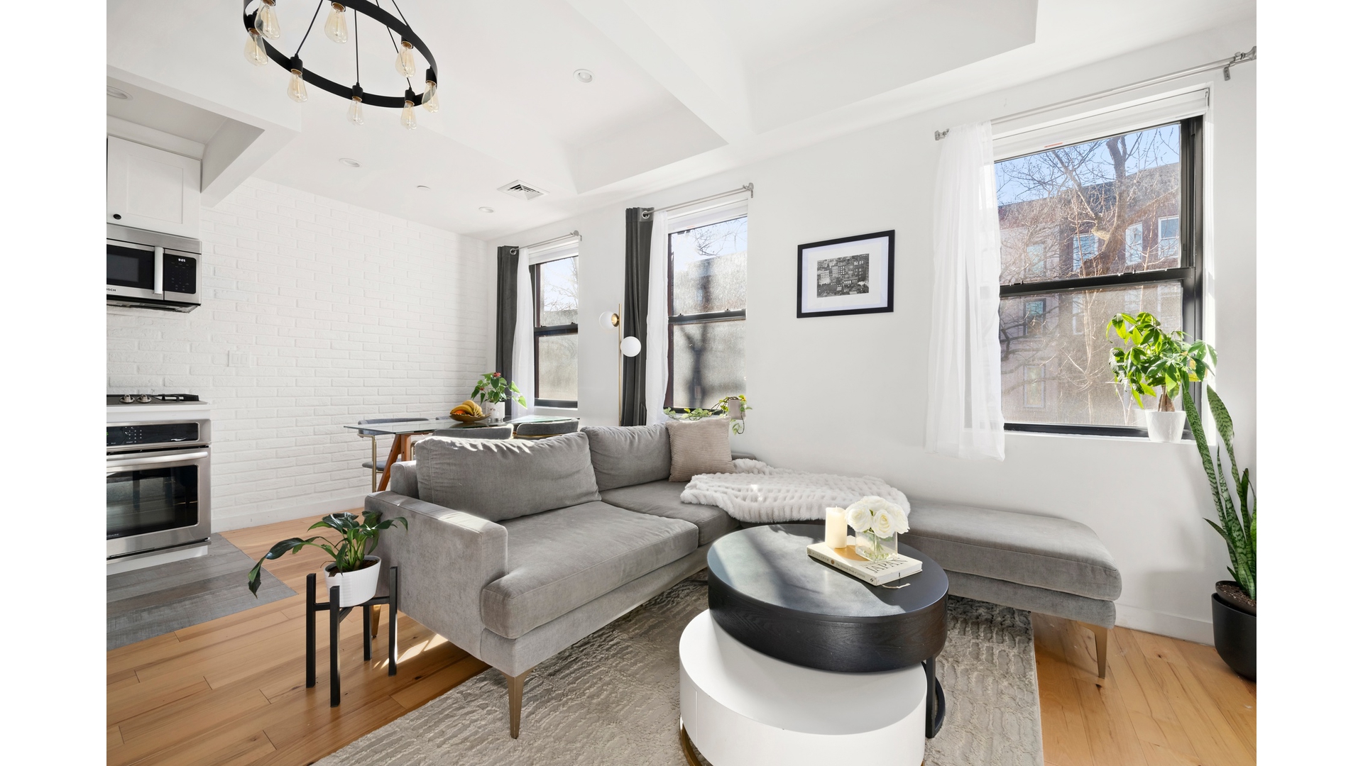 577 Madison Street, Unit 2A Brooklyn, NY 11221 - Photo 3 of 14 a living room with furniture and wooden floor