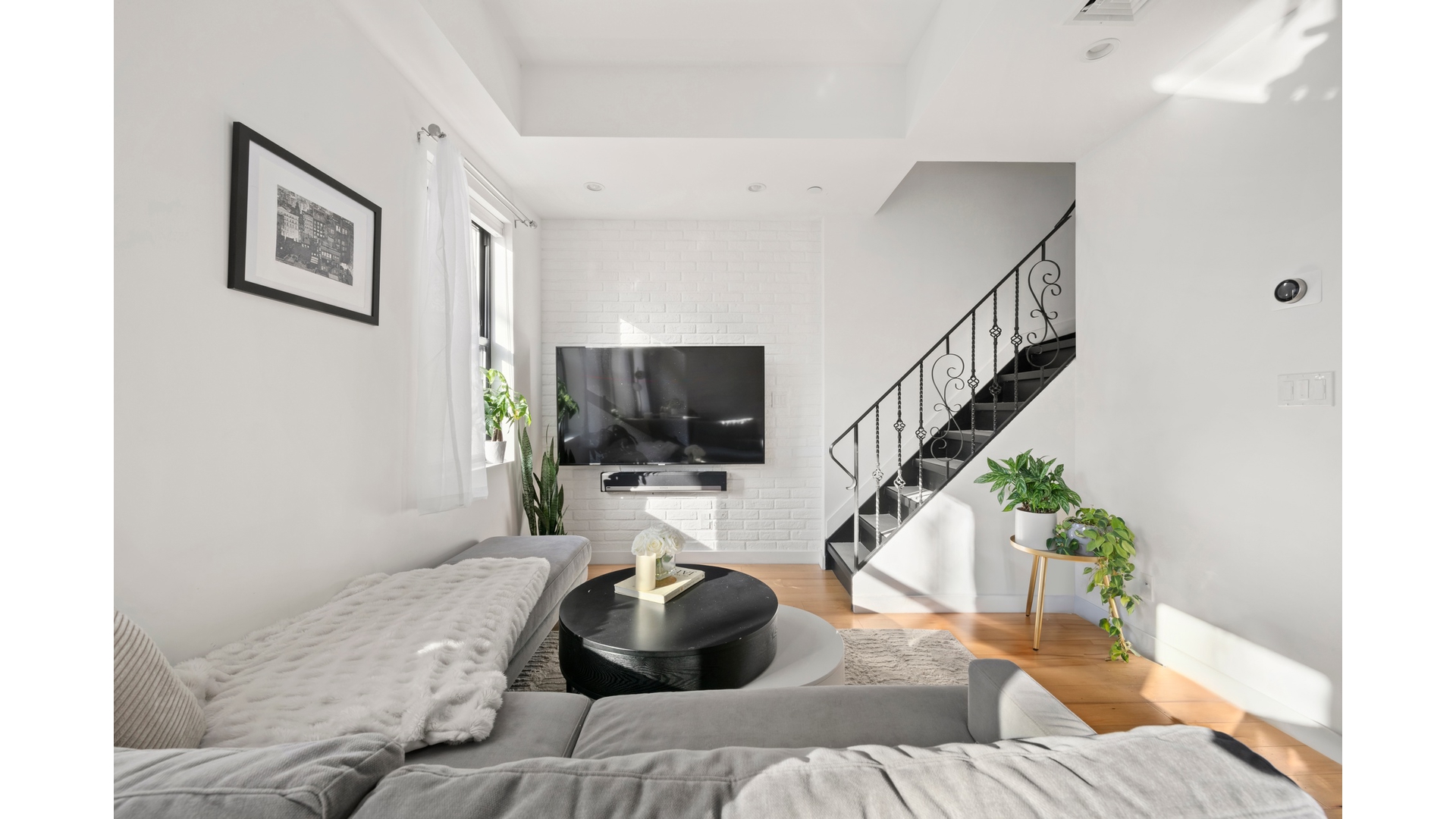 577 Madison Street, Unit 2A Brooklyn, NY 11221 - Photo 4 of 14 a bedroom with a bed and a flat screen tv