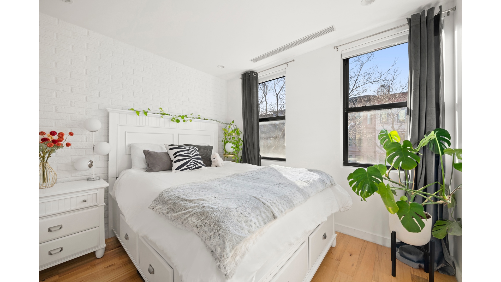 577 Madison Street, Unit 2A Brooklyn, NY 11221 - Photo 9 of 14 a bedroom with a bed and a potted plant