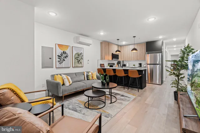 a living room with furniture a dining table and kitchen view