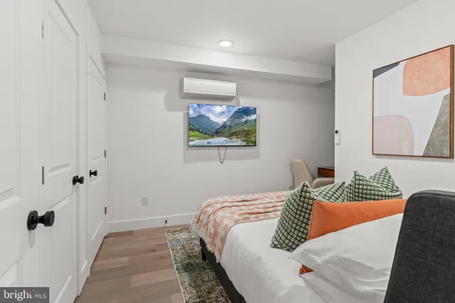 a bedroom with a bed and a painting on the wall